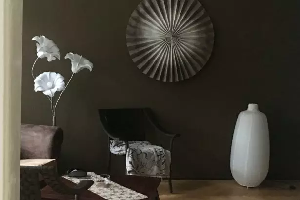 Dark color designed room with white vase and wall decorations. Stylish design