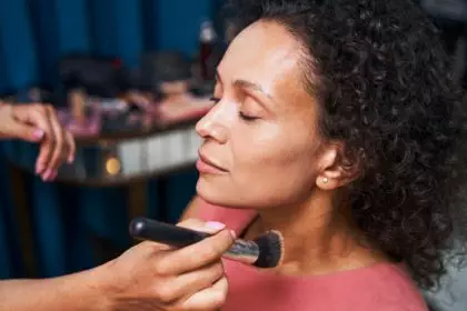 Portrait of relaxed woman doing professional makeup