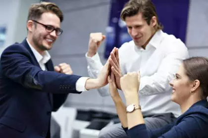 Group of business people celebrating success in office