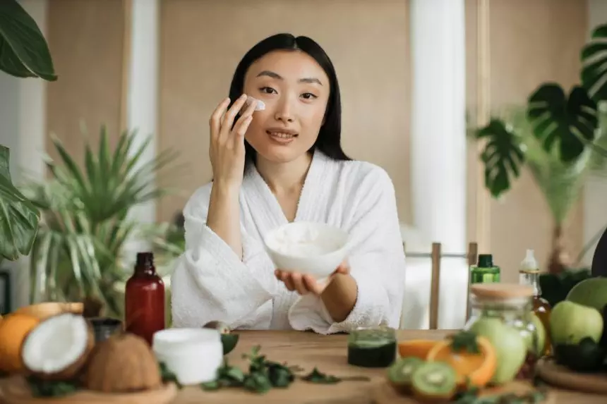 Beautiful asian woman preparing homemade cream with natural ingredients for skin care