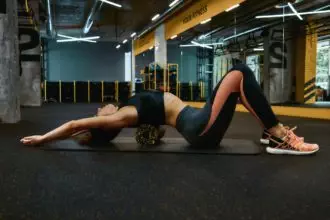 Full relaxation after workout. Full length of a young sportive woman in sportswear exercising with