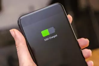 smartphone screen battery charging showing half charged battery in woman hand